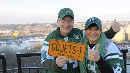 New York Jets fans Marvin and Barbara Schaffer of Long Island show their colors on Mount Washington. Heinz Field is at far left in the background.