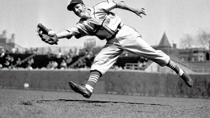 St. Louis Cardinals outfielder Stan Musial reaches to make a catch in this April 23, 1942, photo.