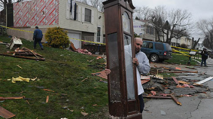 Brian Steiner, of Greensburg, carries a grandfather clock from the Fosterville Road, Hempfield, home of family friend Shirley Clark.