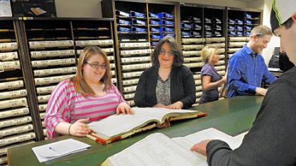 Butler County Recorder of Deeds Michelle Mustello, second from left, helps Meagan Ambrosini, 20, look for grantor records.
