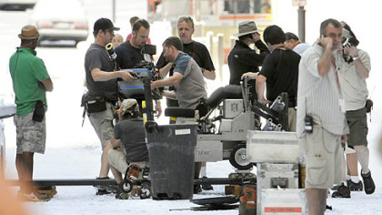 The IMAX camera and dolly track are taken down to prepare for at new shot on snow-covered Oliver Avenue in Downtown Pittsburgh on Aug. 10.