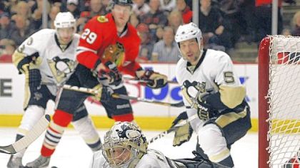 Marc-Andre Fleury deflects the puck away from the goal after a shot by the Chicago Blackhawks in the second period Sunday in Chicago. Fleury had 29 saves but the Blackhawks won in a shootout.