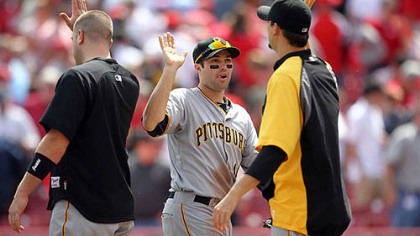 Pirates second baseman Neil Walker, center, is congratulated following Thursday's win against the Reds at Great American Ball Park in Cincinnati.