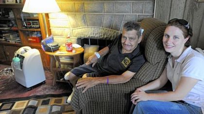 Lindsay Jones sits with her father, Robert Jones, at his home in Greenfield.