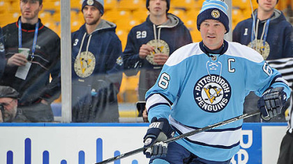 From left to right, Penguins players, Brooks Orpik, Alex Goligoski, Marc-Andre Fleury and Brent Johnson watch owner Mario Lemieux at Heinz Field during Friday's Alumni game.