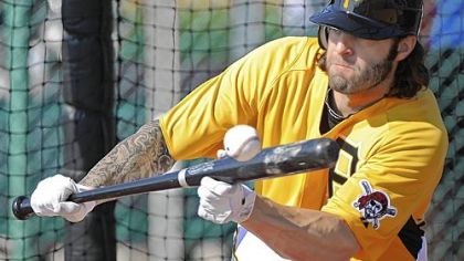 Joe Beimel lays a bunt down in pitcher drills Sunday afternoon at Pirate City in Bradenton, Fla.