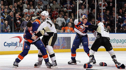 Islanders defenseman Travis Hamonic fights Penguins forward Michael Rupp (right) as Islanders forward Josh Bailey battles Penguins forward Pascal Dupuis during the second period of a game Feb 11, 2011 at Nassau Coliseum in Uniondale, New York. The teams meet again tonight.