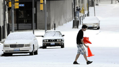 Orange cones to mark a pedestrian crossing are put down at Oliver Avenue and William Penn Place after a blanket of fake snow turns a Downtown Pittsburgh street into Gotham in winter.