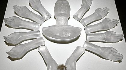 Fumino Hora's "The Way of Samsara" includes a cast glass face and arms, two of which cradle a feather. The title, "Sen-ju: The one who can hear all cries of the world," refers to its inspiration, Sen-ju, a Bodhisattva or being who selflessly delays Nirvana to help others.