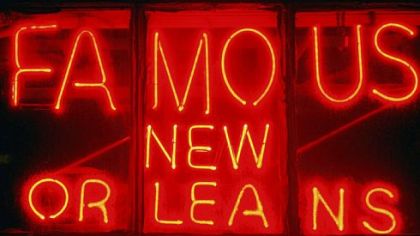 A street sign glows along Bourbon Street.