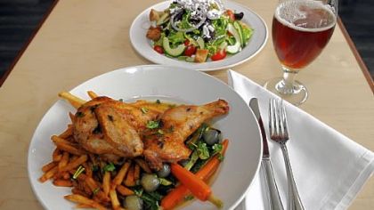 Gerber Farms Roasted Half Chicken served with a pan sauce, Bruges frites and sauteed vegetables, along with a house salad tossed with champagne vinaigrette prepared by Chef Kevin Hunninen at the newly opened Park Bruges in Highland Park.