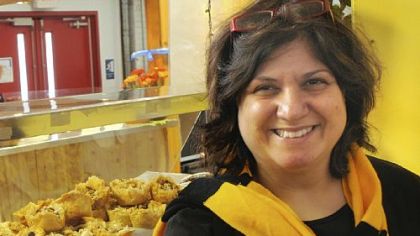 Zelfa Khalil of The Baklava Company at the Pittsburgh Public Market shows a tray of filo footballs decorated in a black and gold theme for the Super Bowl.