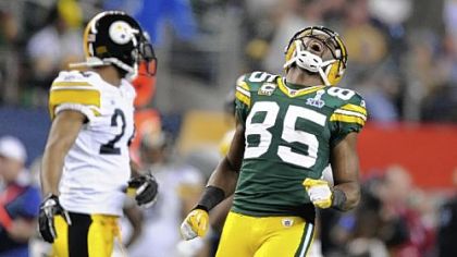 Packers Greg Jennings celebrates in front of Steelers Ike Taylor after pulling in a pass for a first down.