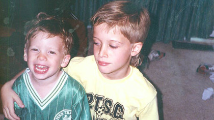 Daniel Garrighan laughs as his older brother, John, puts his arm around him in the family's Penn Township home in a photo from about 1992.