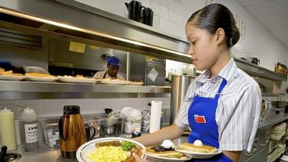 Waitress Ashley Ove picks up an order in the kitchen of an IHOP restaurant on Route 46 in Totowa, N.J. Many of the jobs people are taking as the economy rebounds offer lower pay, fewer hours and worse benefits than some of the 8.75 million positions that disappeared because of the recession, according to a chief U.S. economist at Capital Economics Ltd. in Toronto.
