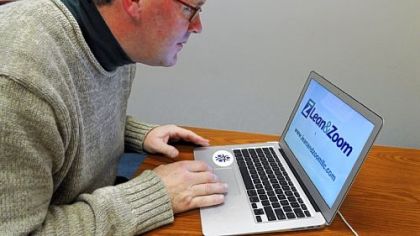 Curt Stone, executive-in-residence at the Carnegie Mellon Quality of Life Technology Center, uses Lean & Zoom software, which detects when your face is getting closer to the screen and enlarges the image.