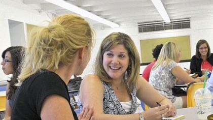 Kim Hoerr, left, a first-grade teacher, and Betsy Miller, center, who teaches kindergarten, work with other teachers to create a mission statement for the new Propel school on the North Side.