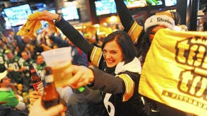Kristina Milasincic of Toronto, Canada, waves a Terrible Towel on Sunday during a toast to Myron Cope at Mullen's on the North Shore on the late announcer's birthday.
