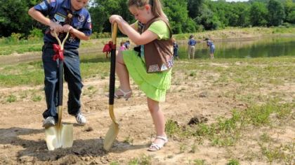 Blake Sham, 9, and his sister, Courtney, 7, of Cranberry dug in after the ground-breaking ceremony for a Scouting monument at Cranberry's Graham Park July 7.