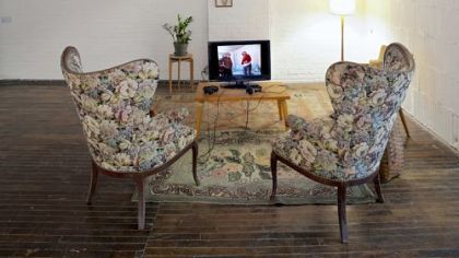 In a homey setting, visitors can watch a video of two friends stepping into each other's shoes in "Metamorphosis Chat/Metamorfoz Muhabbet," as shown in this detail.