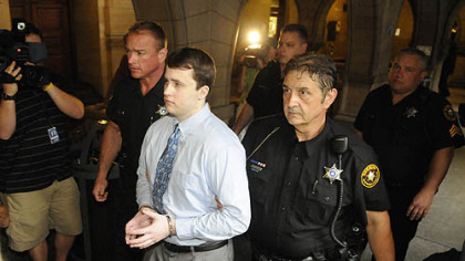 Richard Poplawski is led through the hall of the Allegheny County Courthouse for the start of his trial.