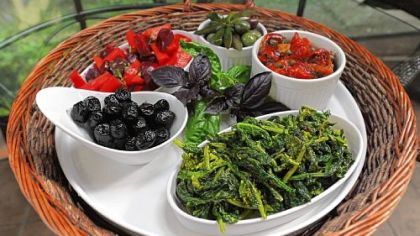Appetizers including blanched carrot and beet salad, roasted peppers with capers, broccoli rabe with hot pepper and assorted olives prepared by Meredith Mileti of Mt. Lebanon.