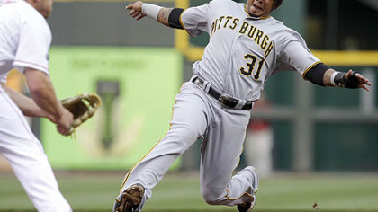 Jose Tabata runs before sliding safely into third as Cincinnati Reds third baseman Scott Rolen waits for the throw in the first inning Monday in Cincinnati. Tabata advanced on a hit by Matt Diaz.