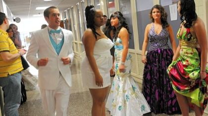 Matt Pucalic runs to escort a girl at the prom fashion show at McKeesport Area High School. There were more girls than there were boys, so the boys had to do double duty. The clothing was provided by Men's Wearhouse of Monroeville.