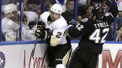 Tampa Bay center Dana Tyrell  slams Matt Niskanen into the boards in the second period of Game 3 of the Penguins-Lightning series Monday in Tampa, Fla.