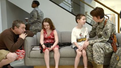 Moments before beginning her journey to the war in Afghanistan, Chris Cieslak (right) begins saying goodbye to son Johnny. Husband Jeff talked with daughter Cara.