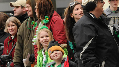 Kellie Milligan, 10, and her brother, Max Milligan, 5, both of Shaler, watch the St. Patrick's Day parade on Grant Street, Downtown, Saturday.