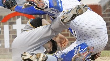 Neil Walker, left, collides with Chicago Cubs catcher Geovany Soto while scoring a run in the ninth inning Sunday at Wrigley Field in Chicago. Walker scored the go-ahead run in the Pirates' 5-4 victory.