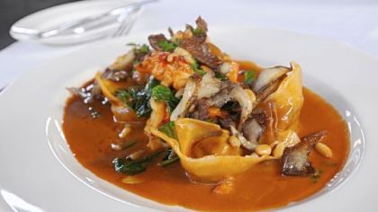 Veal tortelloni with spinach, lobster pieces, oyster mushrooms and pine nuts, sauced with a butter-enriched reduction of lobster stock at Casbah.