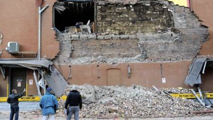 Pittsburgh building inspectors examine the partial collapse of a brick wall at S&S Candy and Cigar Co. at South 21st and East Carson streets on the South Side Monday morning.