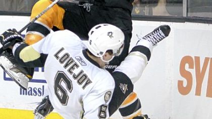 Penguins defenseman Ben Lovejoy falls to the ice after colliding with the Boston Bruins' Milan Lucic in Saturday's game in Boston.