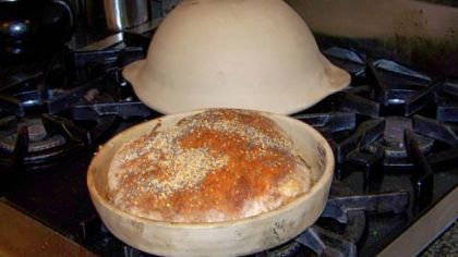 Bread baked in a clay pot with the lid.