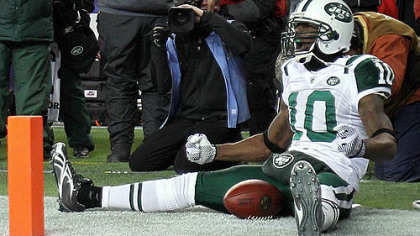 Jets receiver Santonio Holmes  celebrates his fourth-quarter touchdown against the Patriots Sunday in Foxborough, Mass.