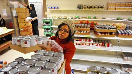 Cynthia Washington, Northside Common Ministries food bank coordinator, restocks shelves at the Brighton Road location.