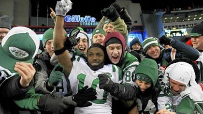 Santonio Holmes of the New York Jets celebrates with fans after the Jets defeated the Patriots 28-21 in their AFC divisional playoff game at Gillette Stadium Sunday.
