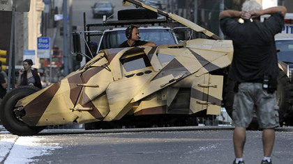 A Tumbler driver maneuvers the vehicle in reverse to reposition it for the next take as the crew of "The Dark Knight Rises" films stunt scenes along Cherry Way on Thursday, Aug. 18.
