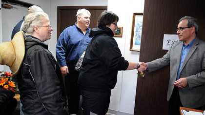Katrina Sainovich, 22, from Industry, a recent Duquesne University graduate, shakes the hand of Jim Ferruchie, deputy district director for U.S. Rep. Jason Altmire.