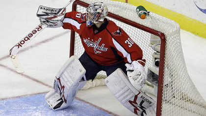 Washington Capitals goalie Michal Neuvirth deflects a shot from the Penguins in the first period.