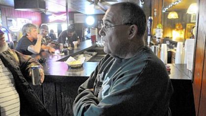 Shawn Culleton, 53, a retired coal miner from Leckrone, drinks some beer at Mario's, north of Masontown, Friday night and talks about the cancellation of the $200 million medium-security prison.