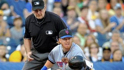 Jose Tabata is tagged out by the Mets' Justin Turner but was ruled safe at third because of an interference call against Mets shortstop Jose Reyes in the first inning.