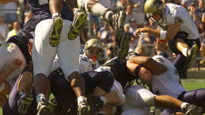 Penn State's Lavar Arrington (11) blocks a field goal try from Pitt's Nick Lotz, right, in the final minute of the 1999 rivalry game in State College. Penn State won, 20-17.