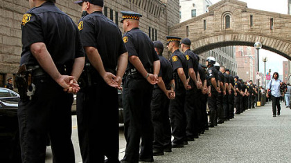 More than 100 officers from Pittsburgh and surrounding areas stood at attention as the families of Pittsburgh Police Officers Eric G. Kelly, Stephen J. Mayhle and Paul J. Sciullo II arrived at the Allegheny County Courthouse.