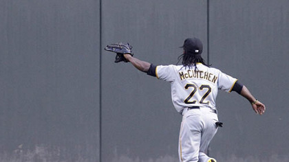 Andrew McCutchen chases a ground rule double hit by the Reds' Scott Rolen into center field in the second inning Monday.