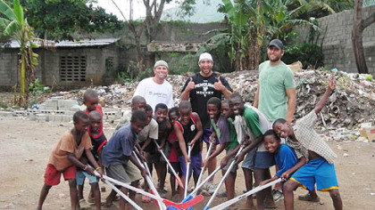 Penguins chaplain Brad Henderson, Penguins Max Talbot, Mike Rupp and orphans play with plastic hockey sticks during a trip to Haiti in August.