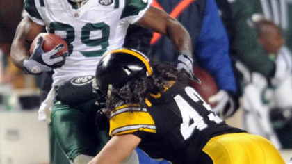 Former Jets receiver Jerricho Cotchery, seen here tangling with Troy Polamalu in the AFC Championship game in January, signed a deal with the Steelers.