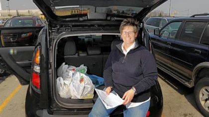 Lisa Hildreth of Churchill poses for a portrait at her vehicle in the parking lot of the North Versailles Wal-Mart, one of several locations where she shops for her business, BestGroceryDelivery.net.